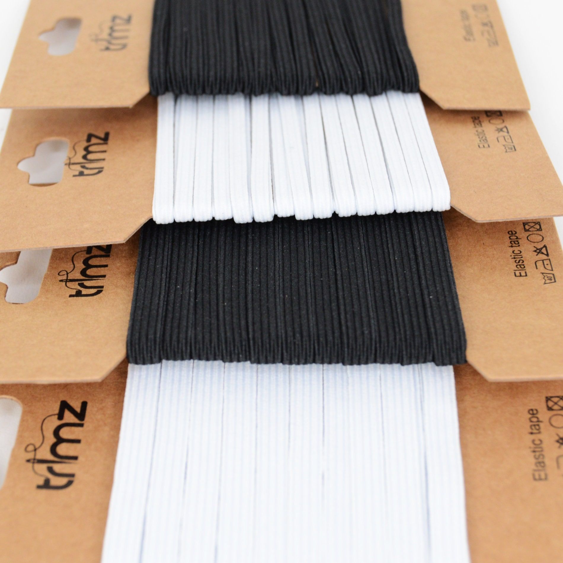 Trimz braided elastic on a card black/white group shot close up